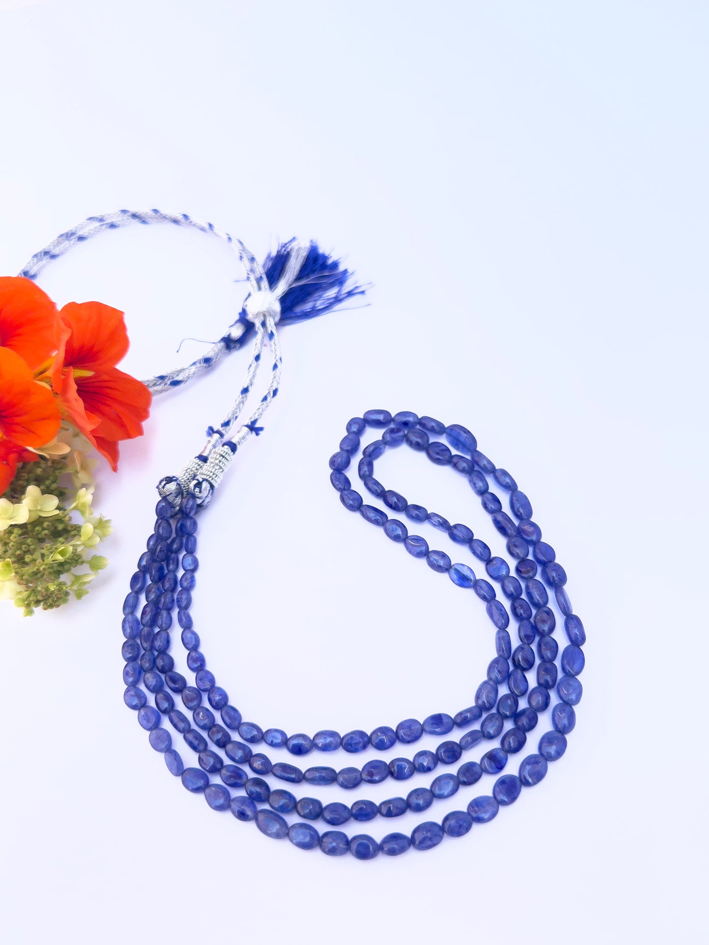 Blue Sapphire necklace showcasing gemstone beads, smooth oval cut, versatile styling.