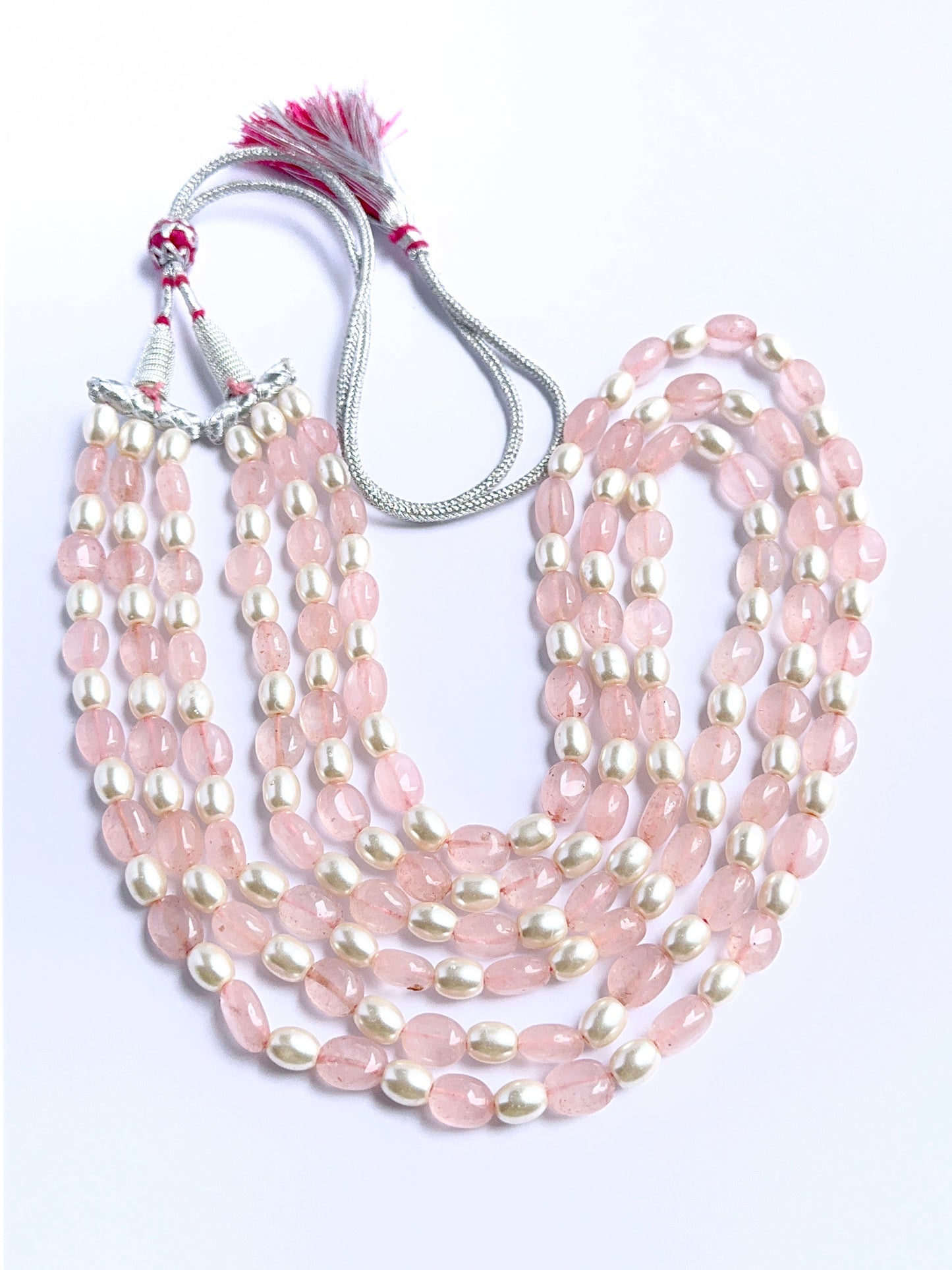 Elegant multi‑strand gemstone necklace featuring quartz and shell pearls