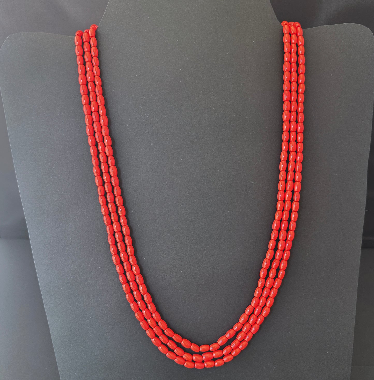 Necklace with delicate strands of Taiwan Coral beads, showcasing their smooth design.