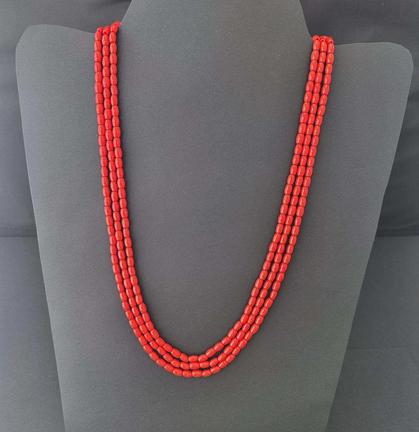 Three-strand Taiwan coral necklace with adjustable finish, crafted from polished natural gemstone beads.