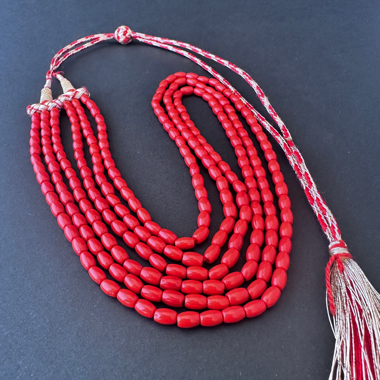 Close-up of smooth drum coral beads, 212 carats, highlighting clarity and natural gemstone beauty.