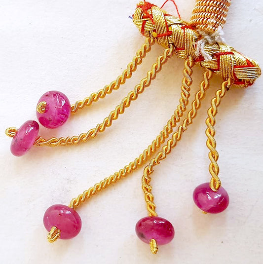 High-quality ruby gemstones in smooth rondelle cut reflect natural brilliance and rich saturation.