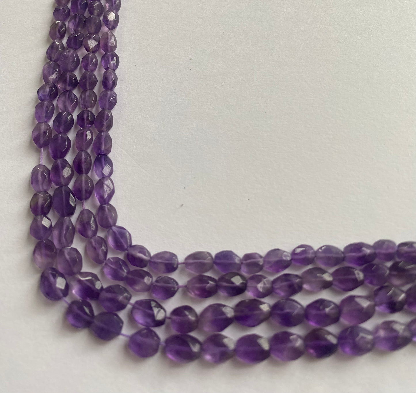Beautiful purple amethyst stones, faceted oval, measuring between 5.5mm and 6.5mm.