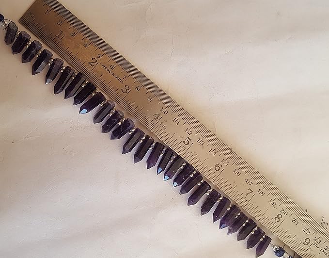 A purple gemstone bead strand showcasing Amethyst smooth pencil shaped gemstones.
