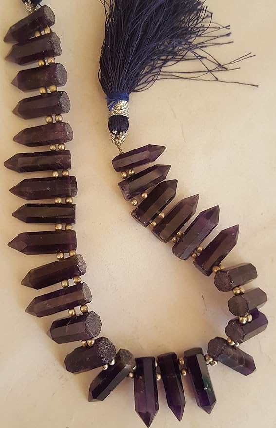Close-up of a purple gemstone bead strand highlighting Amethyst gemstones.