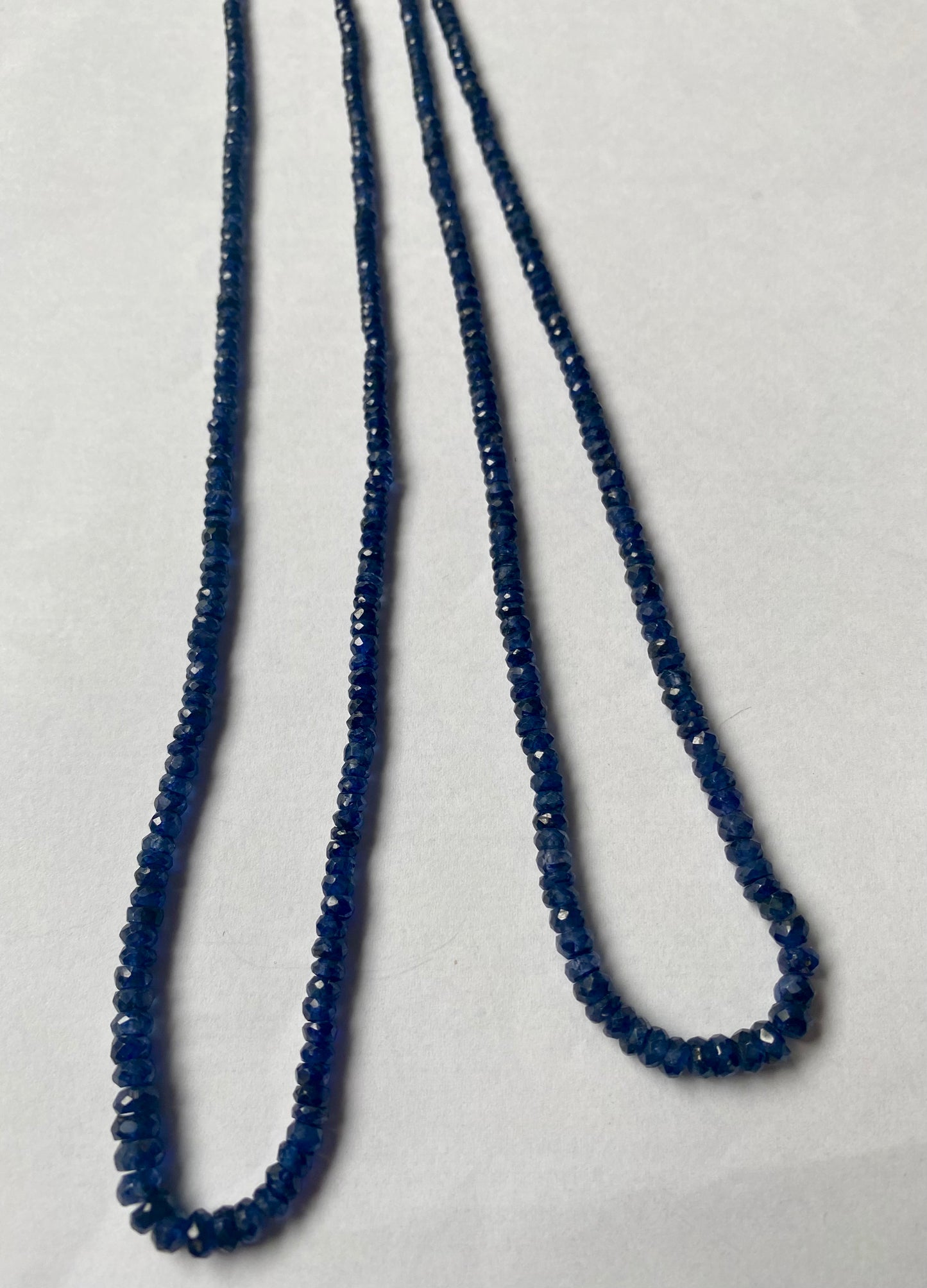 Beautiful strands of precious blue sapphire gemstone beads, featuring faceted rondelles sized between 2.5mm and 5mm, radiating elegance.
