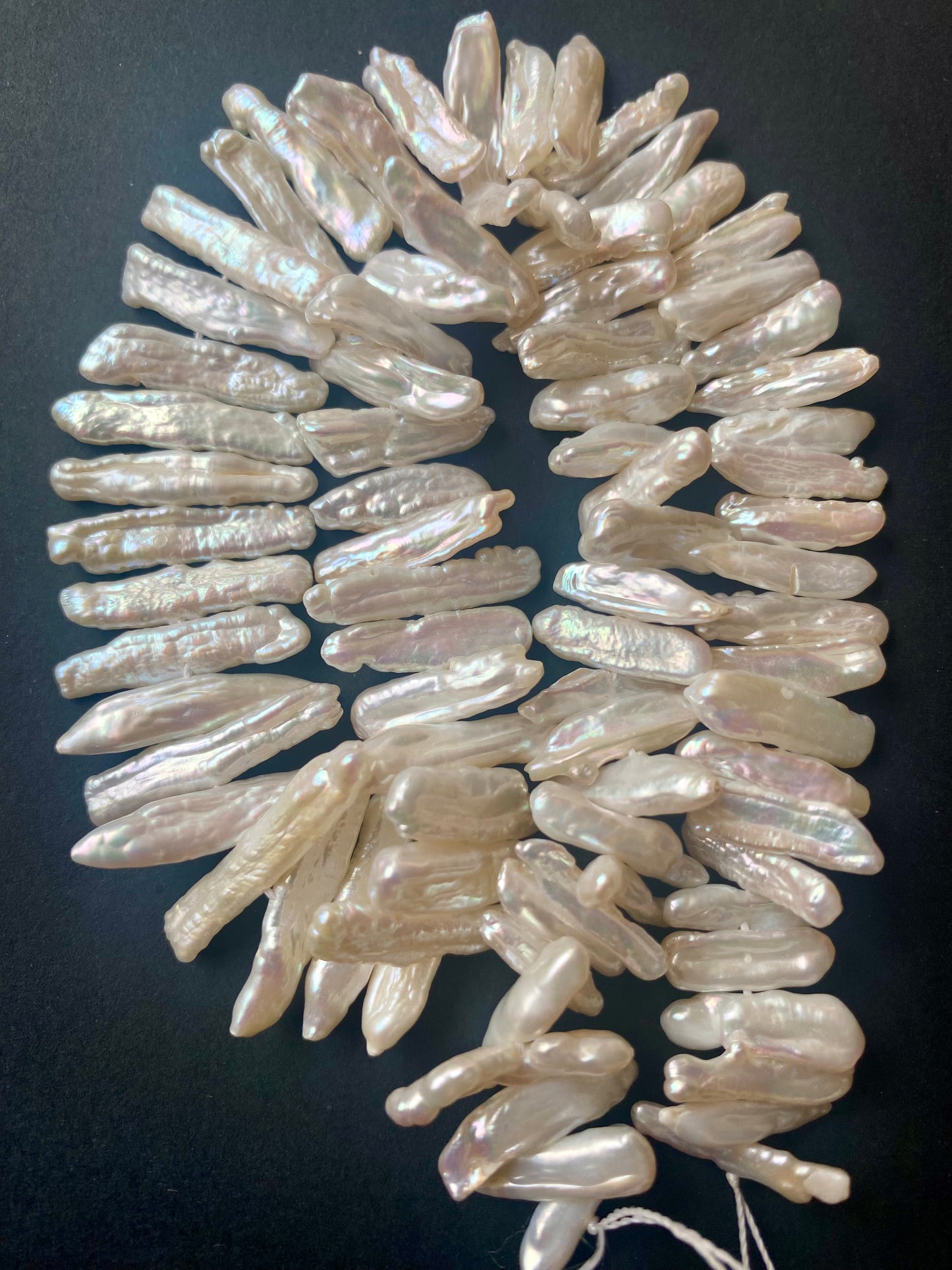 Macro image of Baroque pearls highlighting their natural contours and soft iridescence.