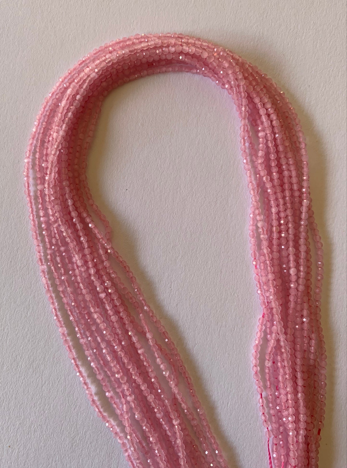 A beautiful strands of natural chalcedony beads, featuring pink faceted rondelles, perfect for jewellery making.