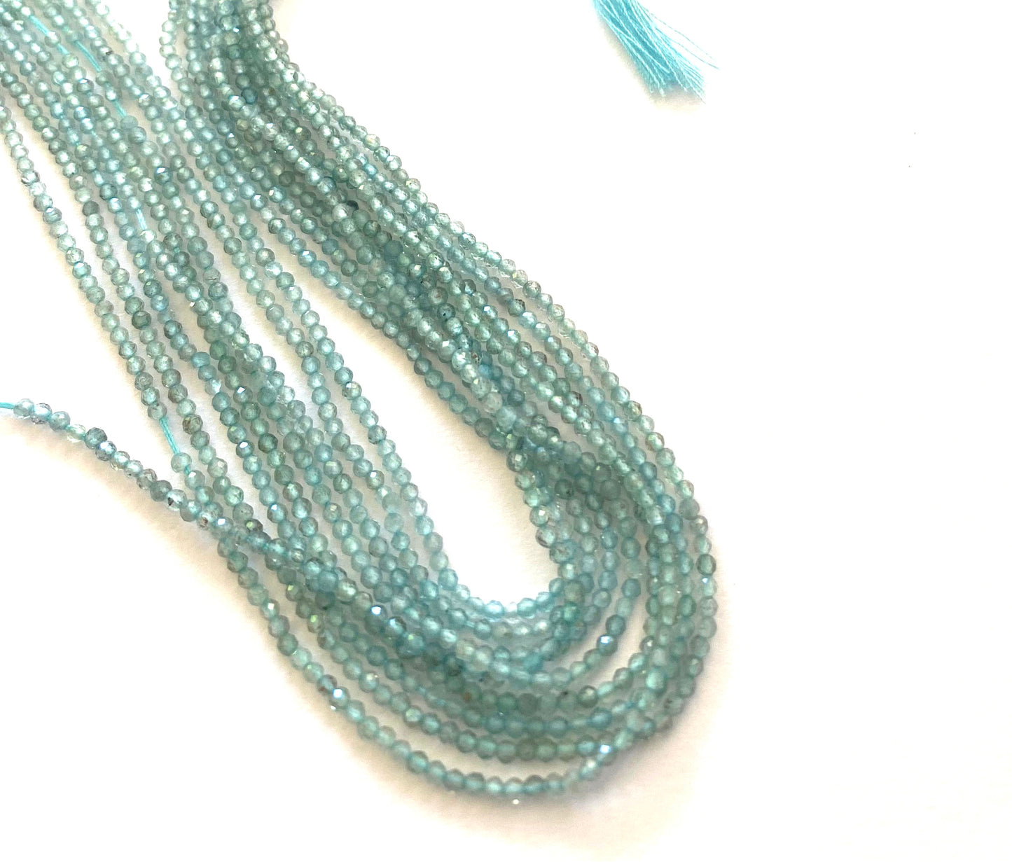 A close-up of a multiple strands featuring chalcedony faceted rondelle beads, measuring 2mm in size.