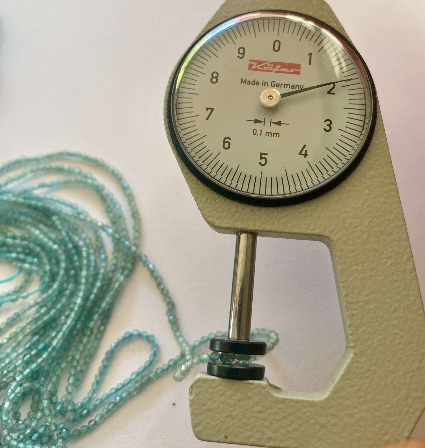 A close-up of a strands featuring Chalcedony faceted rondelle beads, measuring 2mm in size.
