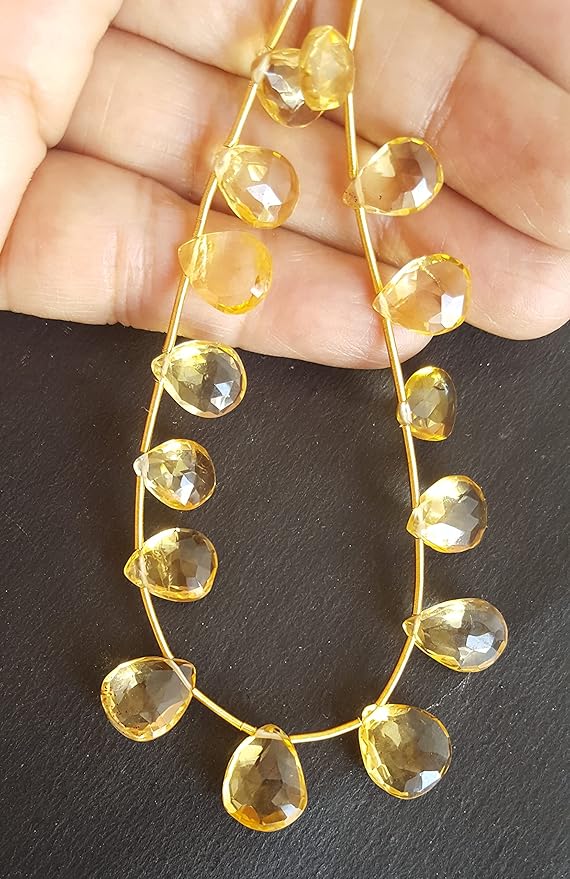 Strand featuring faceted pear beads in a vibrant yellow colour, showcasing the beauty of Citrine.