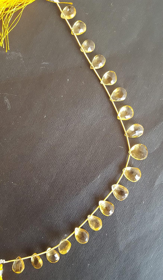 A close-up of a strand featuring red beads displayed on a sleek black surface, highlighting its vibrant colour contrast.