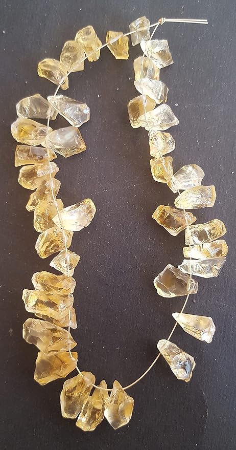 Natural raw Citrine gemstone bead strand featuring irregular, unpolished golden-yellow stones with translucent clarity and natural inclusions.