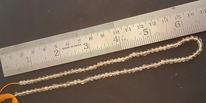 A citrine stand made of smooth,rondelle beads, with a ruler beside it for size reference.