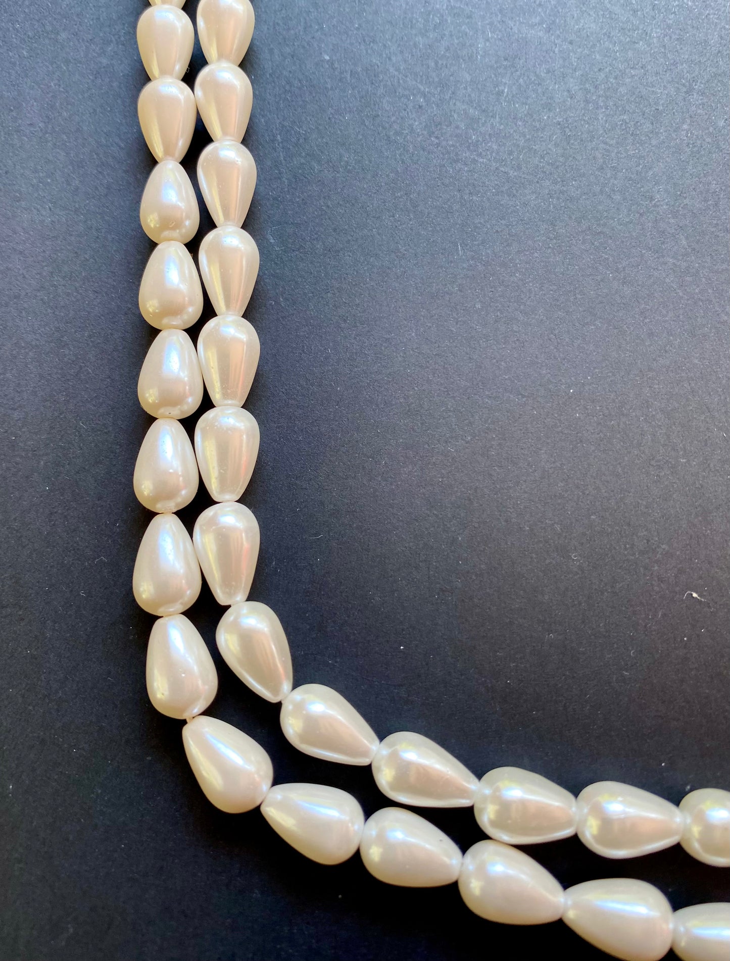 Cone freshwater pearls, 8-12mm, elegantly displayed on a sleek black surface.