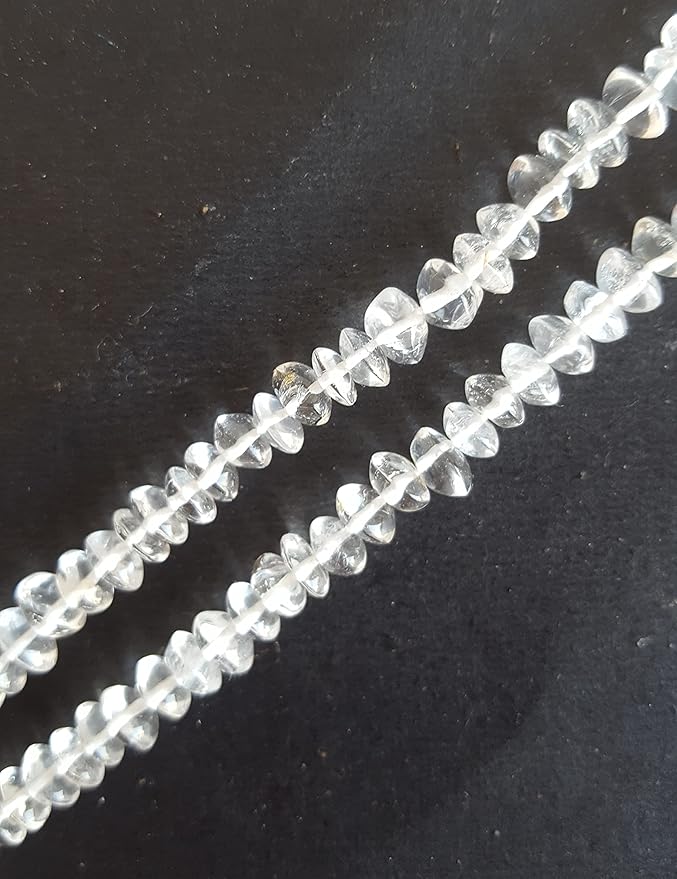 A crystal bead on a dark background, featuring capturing light beautifully.