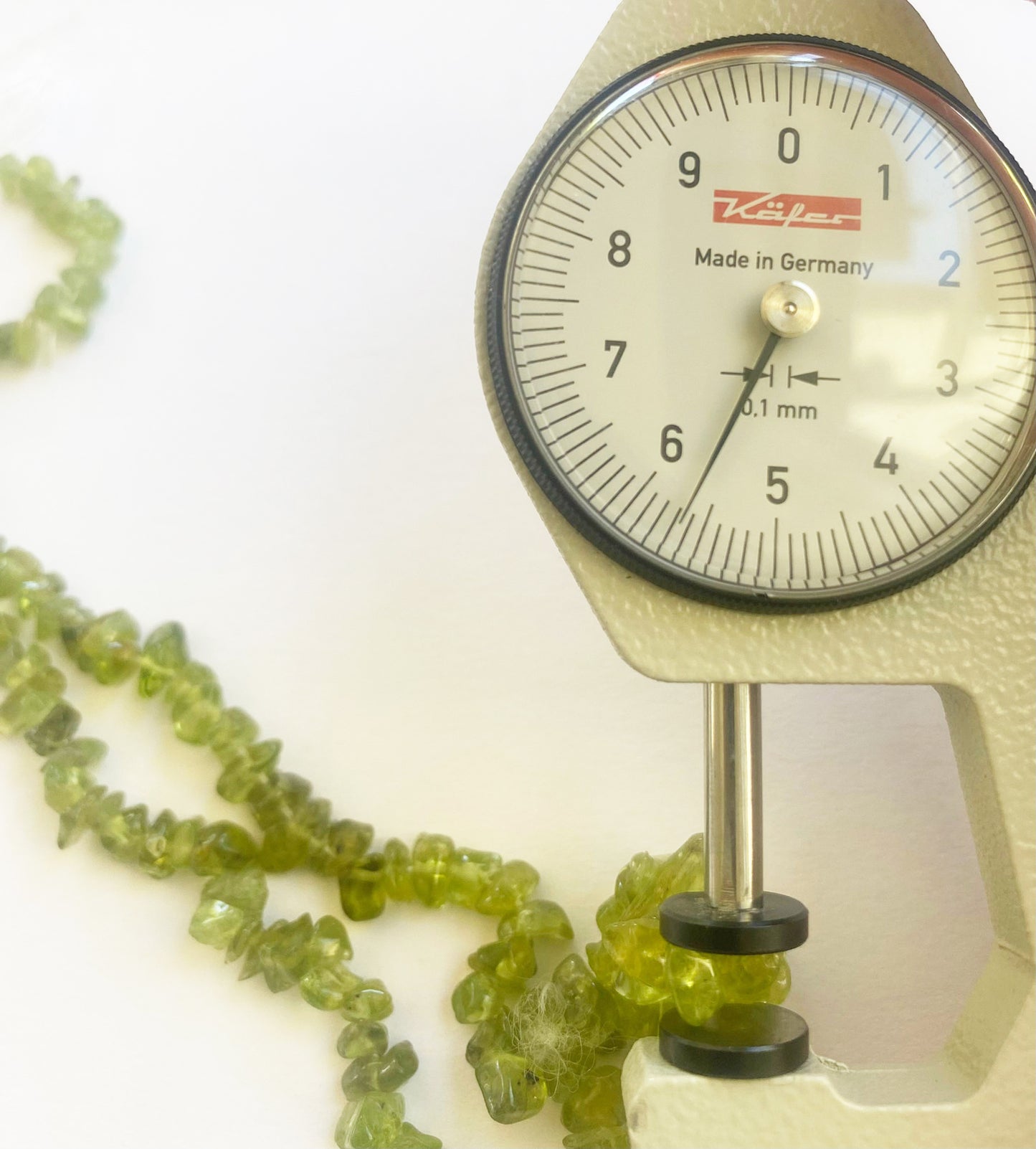 Premium Peridot chip beads 5 to 8mm arranged in strands to display their vibrant green tones and superior gemstone craftsmanship.
