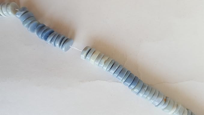 A stunning strand adorned with various coloured Denim Opal gemstone beads, showcasing smooth wheel designs.