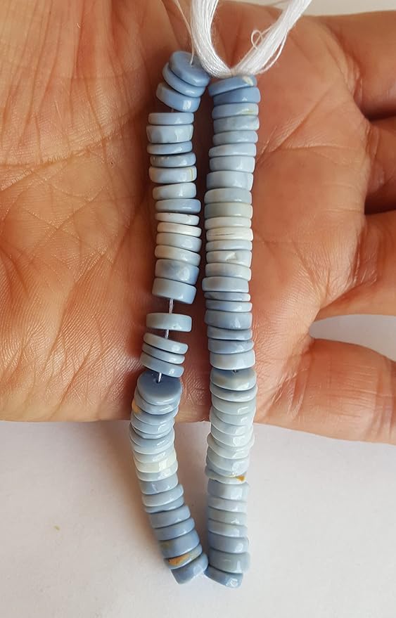Close-up of a person holding a colourful gemstone strand made with Denim Opal Heishi smooth wheel beads, showcasing its vibrant design.