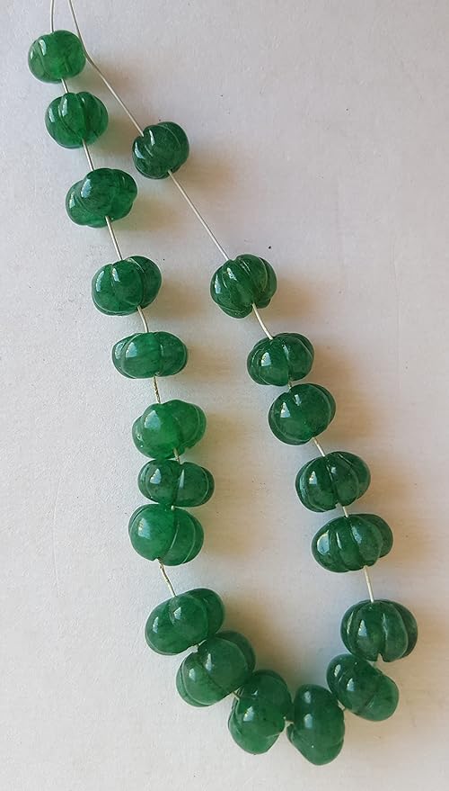 Strand featuring carved rondelle beads in a vibrant green colour, showcasing the beauty of Emeralds.