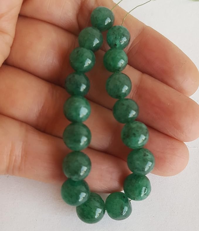 A strand of green Emerald beads, featuring 7mm to 9mm smooth round shaped gemstones, showcasing their vibrant colour and shine.