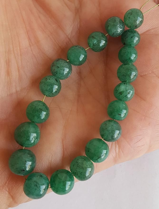 A strand of green Emerald beads, featuring 7mm to 8mm smooth round shapes, showcasing their vibrant colour and shine.