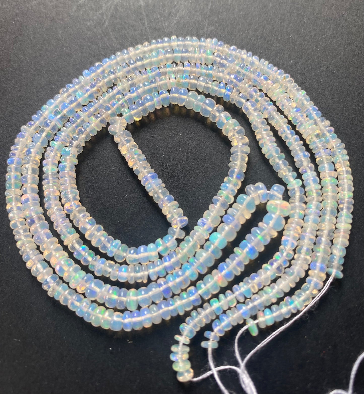 Stunning 3.2-4.2mm smooth white opal gemstone beads, reflecting the unique charm and hue.