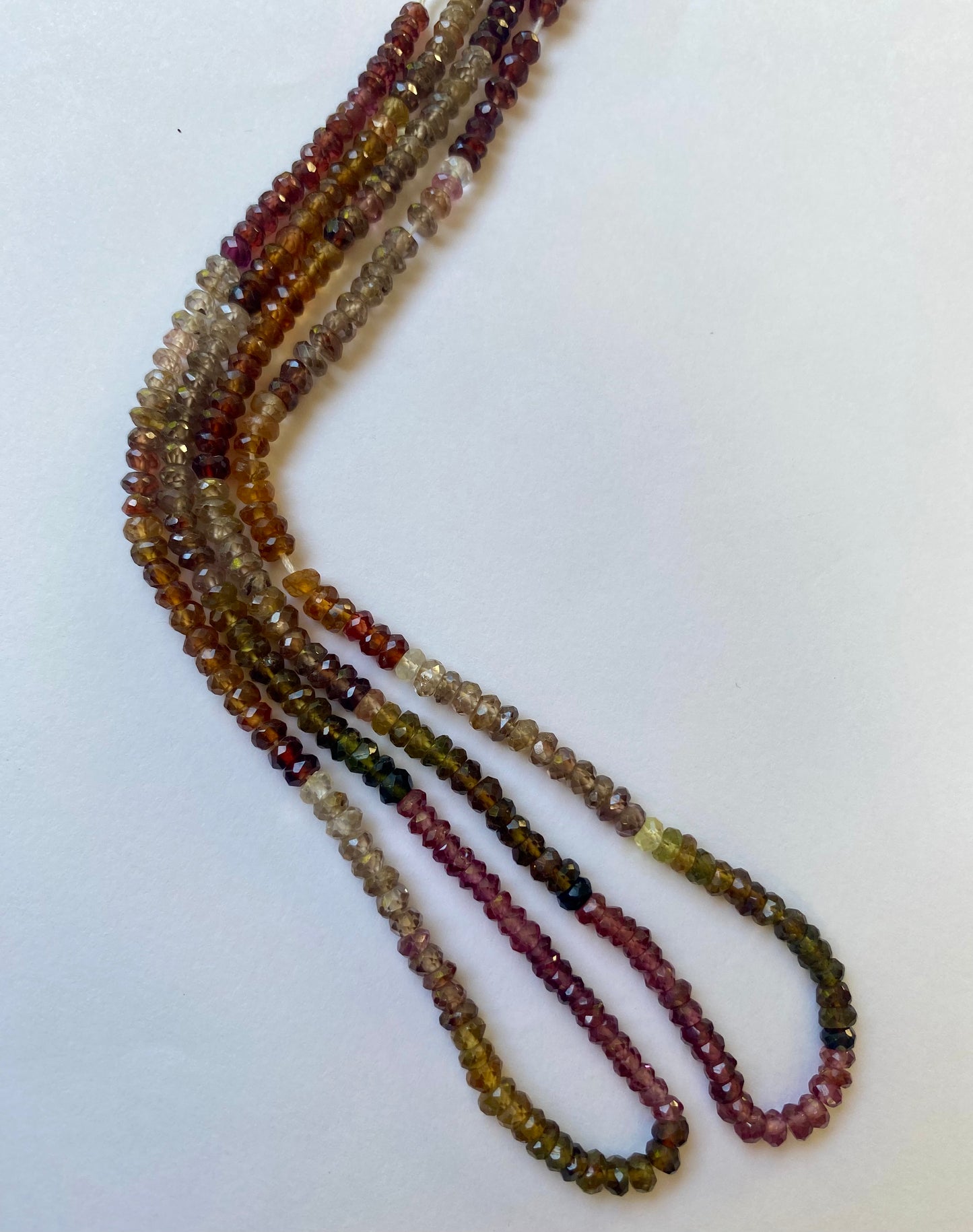 Multicoloured faceted Tourmaline glass beads, 3.5-4mm in size, strung together to create a stunning visual display.