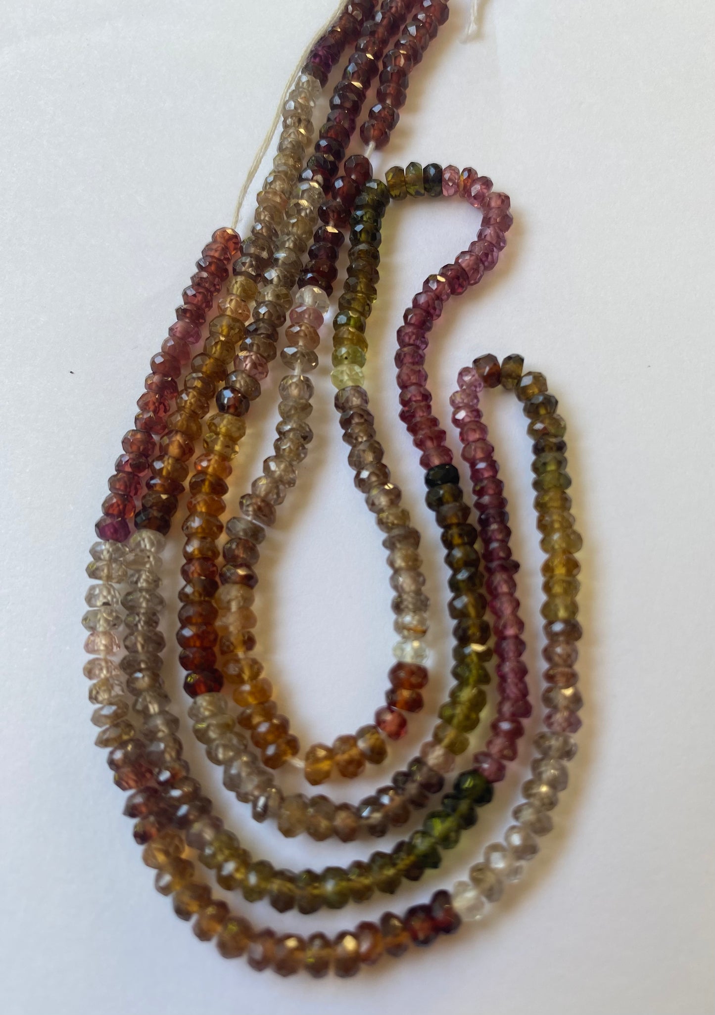 A strand of multicoloured faceted Tourmaline glass beads, each measuring 3.5-4mm in size, showcasing vibrant hues.