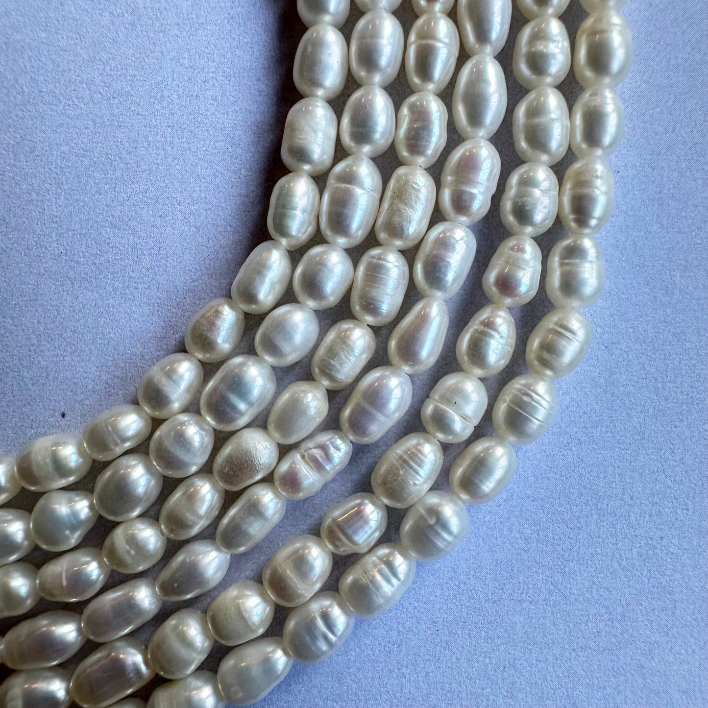 A jewellery designer arranges Fresh Water Pearl beads, crafting exquisite pearl creations