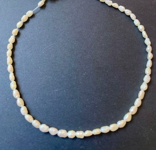 Elegant strand of freshwater Baroque rice pearls, showcasing beads of 3.2-3.7 mm.