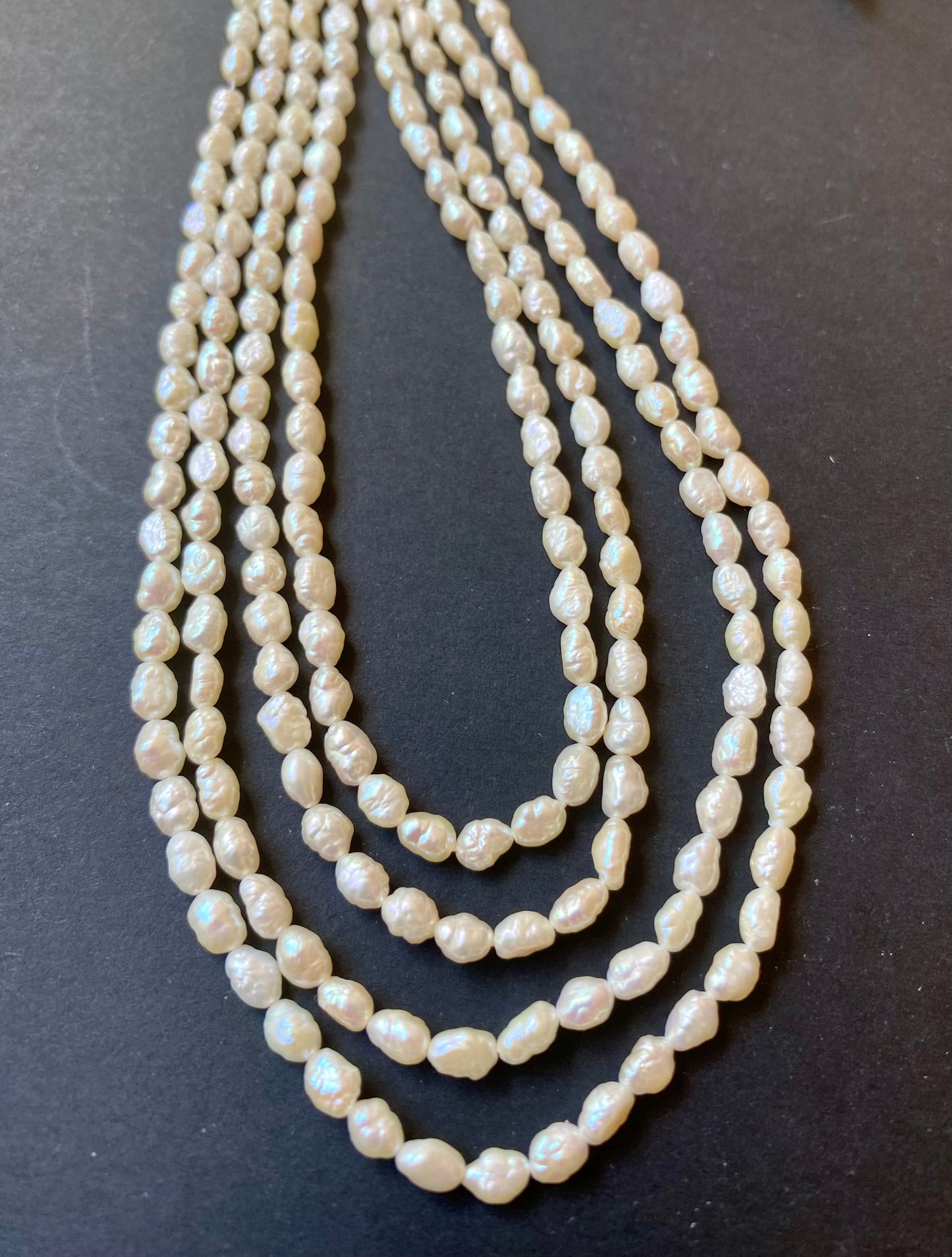 featuring multiple strands of freshwater Baroque rice pearls, each bead measuring 3.2-3.7 mm in size.
