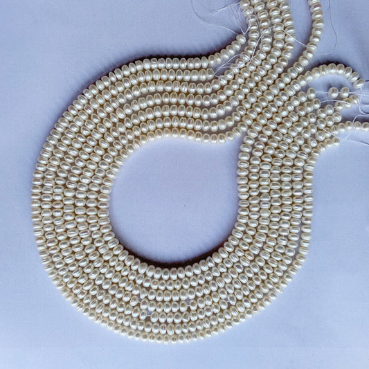 Close-up of Freshwater Pearl smooth rondelle beads reveals their elegant shape and radiant, flawless surface.