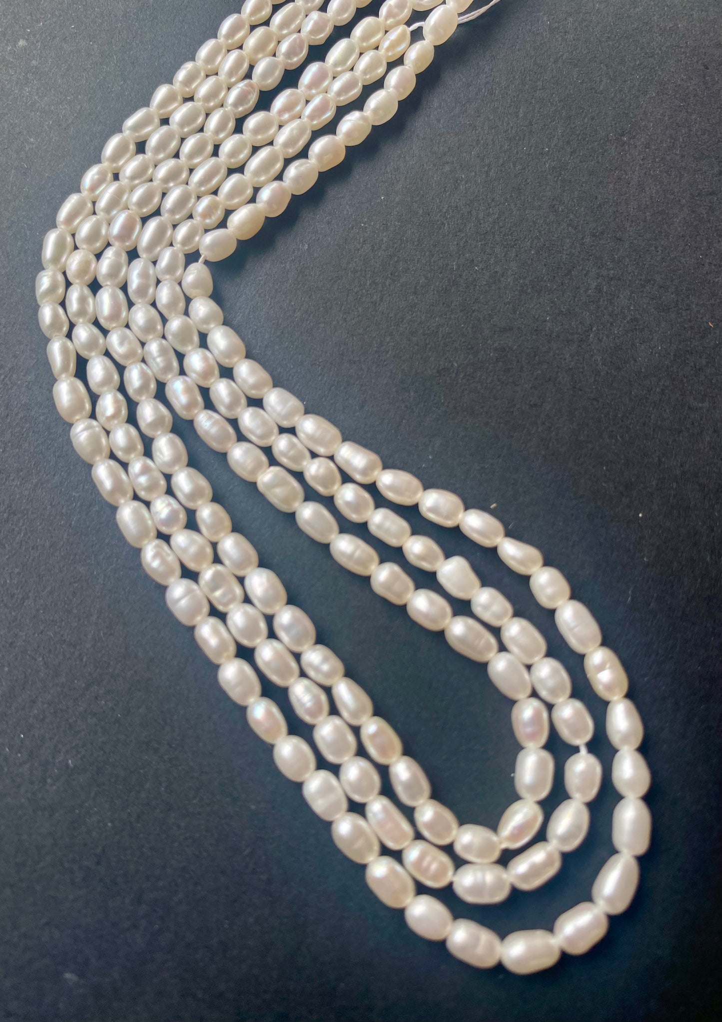Strands of freshwater rice pearls, each pearl measuring 3.1-3.5mm.
