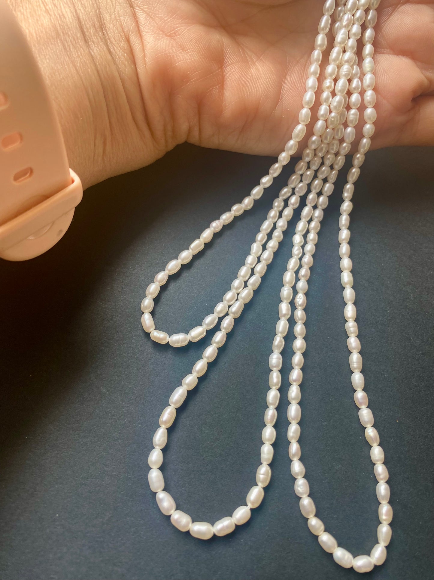 Three strands of freshwater rice pearls, measuring 3.1-3.5mm, elegantly arranged.