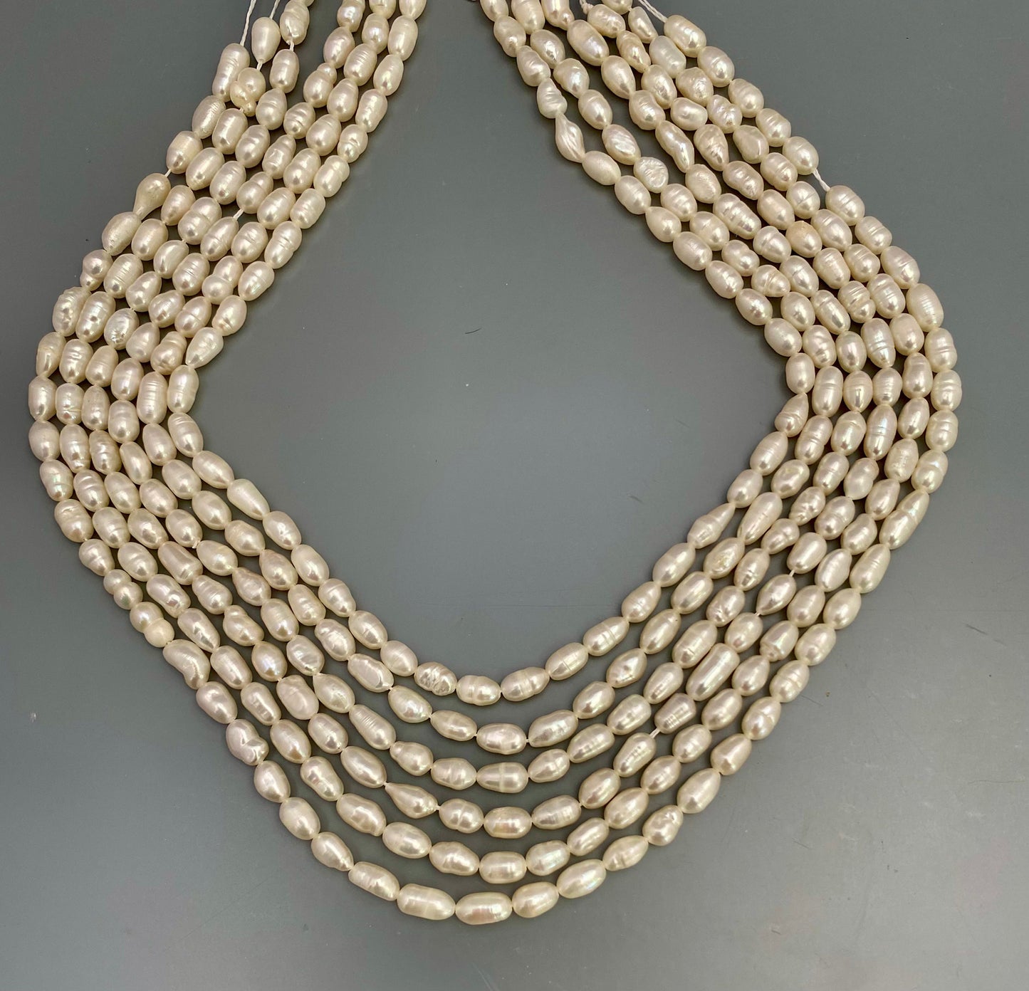 A close-up of freshwater baroque pearls with organic curves and delicate hues.