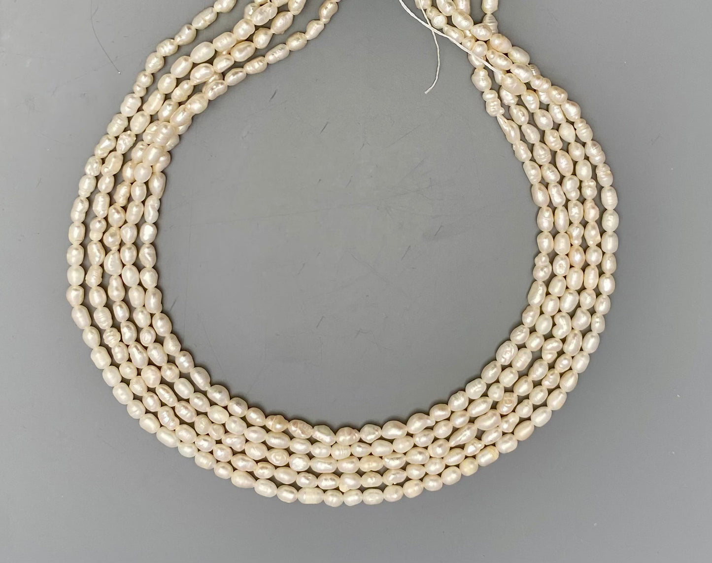 Lustrous freshwater baroque rice pearls, 3.4mm to 3.8mm, delicately strung on a 34cm strand.