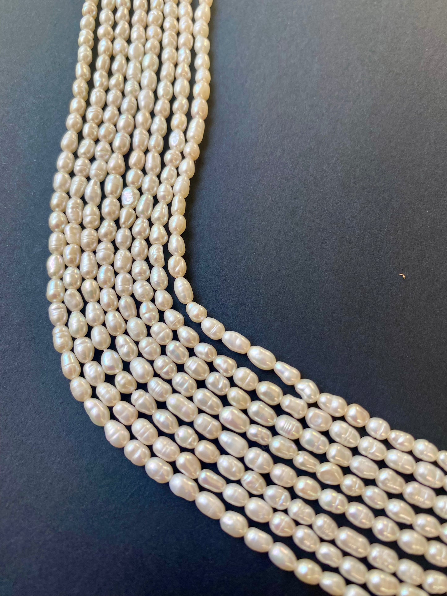 Composed of several strands of 3.5mm freshwater rice pearls, radiating timeless elegance.