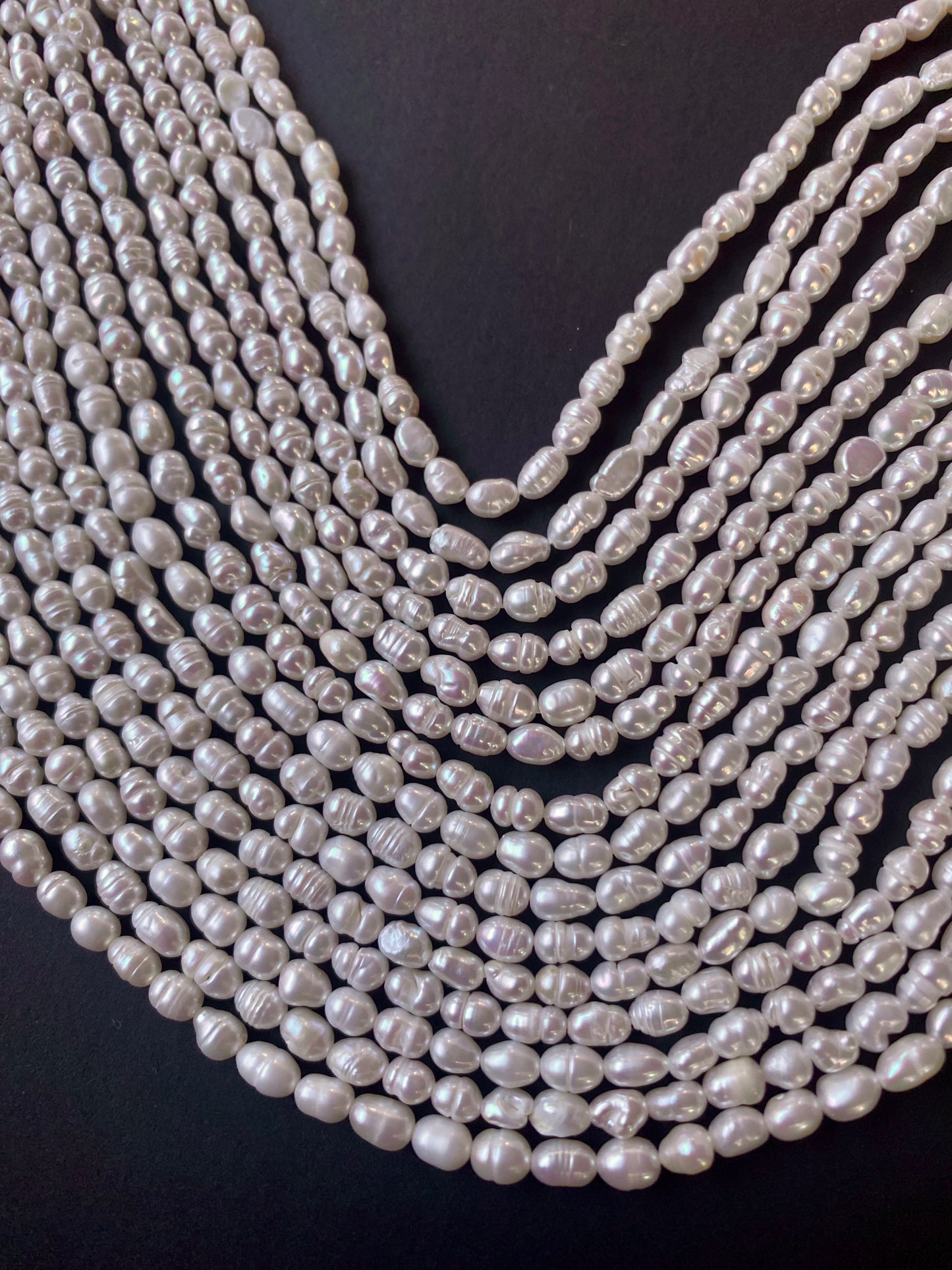 Elegant multiple strands of 3.5-4mm white freshwater rice pearls, showcasing their natural beauty.