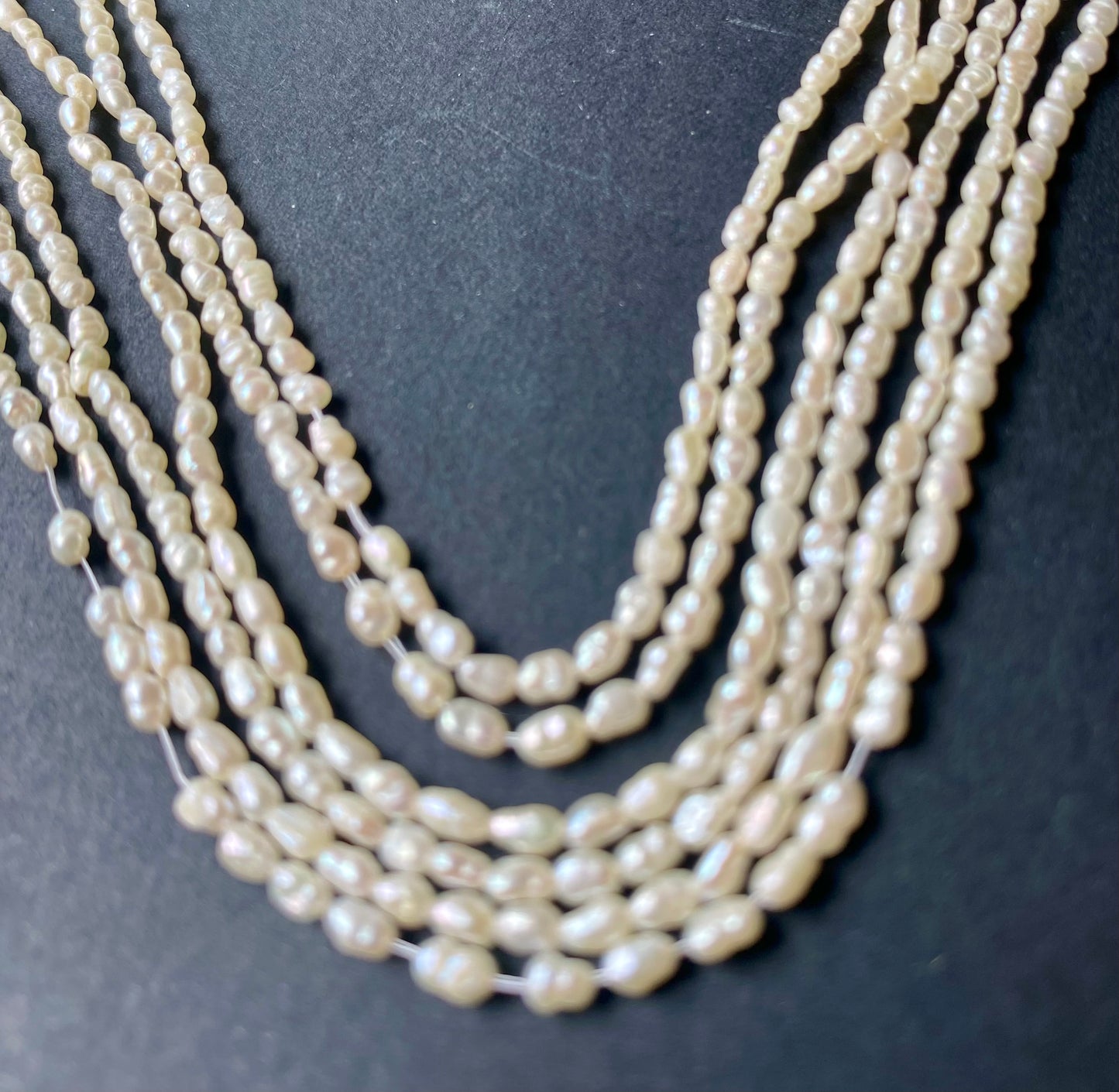 Several strands of white freshwater rice pearls, each measuring 2-2.2mm in size.