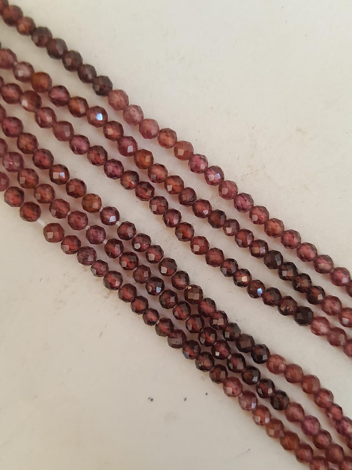 A gemstone bead strand showcasing Garnet faceted rondelle gemstones.