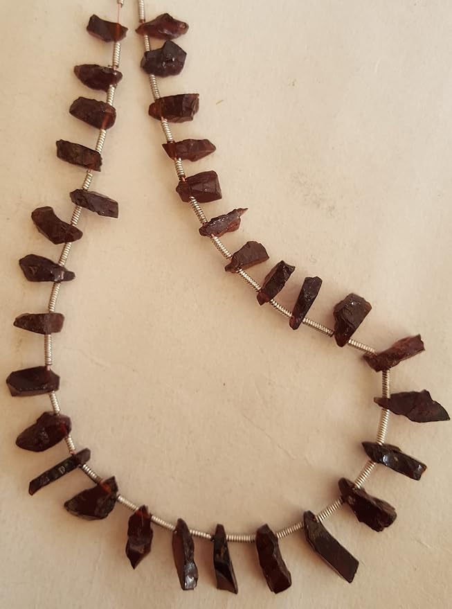 A strand crafted from rough natural garnet gemstone radiating warmth and elegance.
