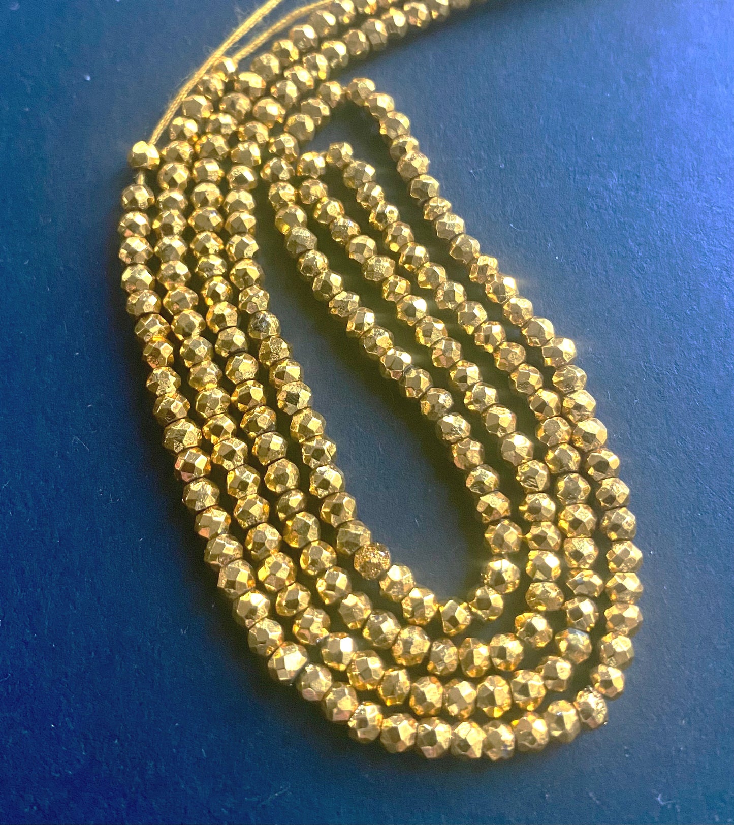 Lustrous Gold Pyrite Faceted Rondelle beads, 2.2-2.3mm, elegantly strung on a 31cm strand.