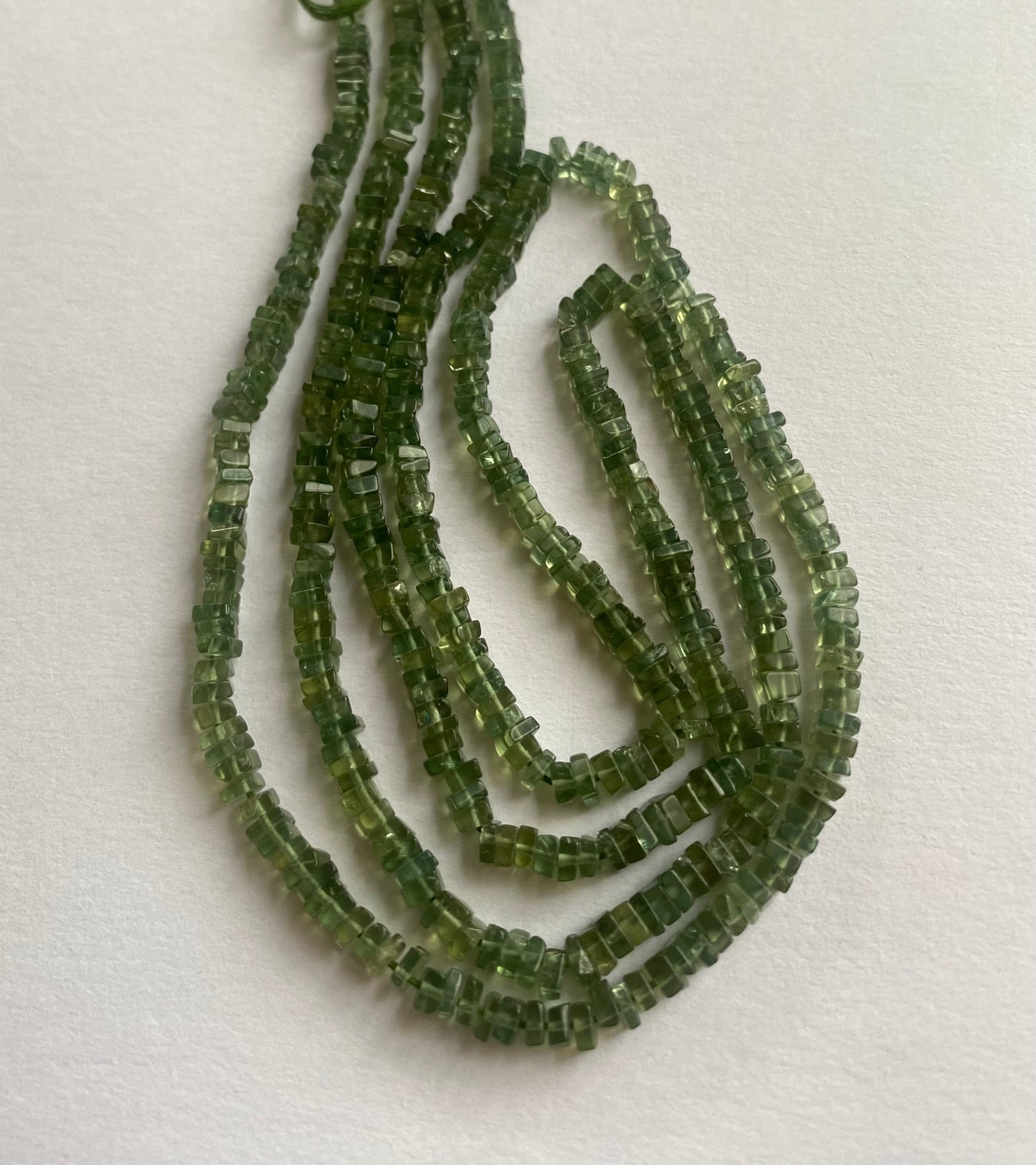 Beautiful green apatite stones,smooth square-shaped measuring between 3.0mm and 3.5mm.
