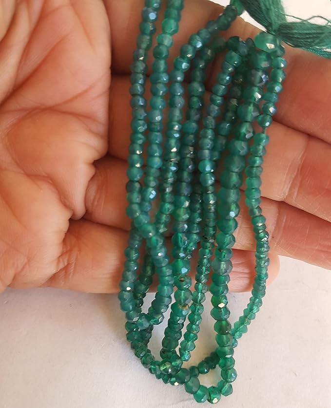 A strand of green Onyx beads, featuring faceted rondelle shapes, showcasing their vibrant colour and shine.