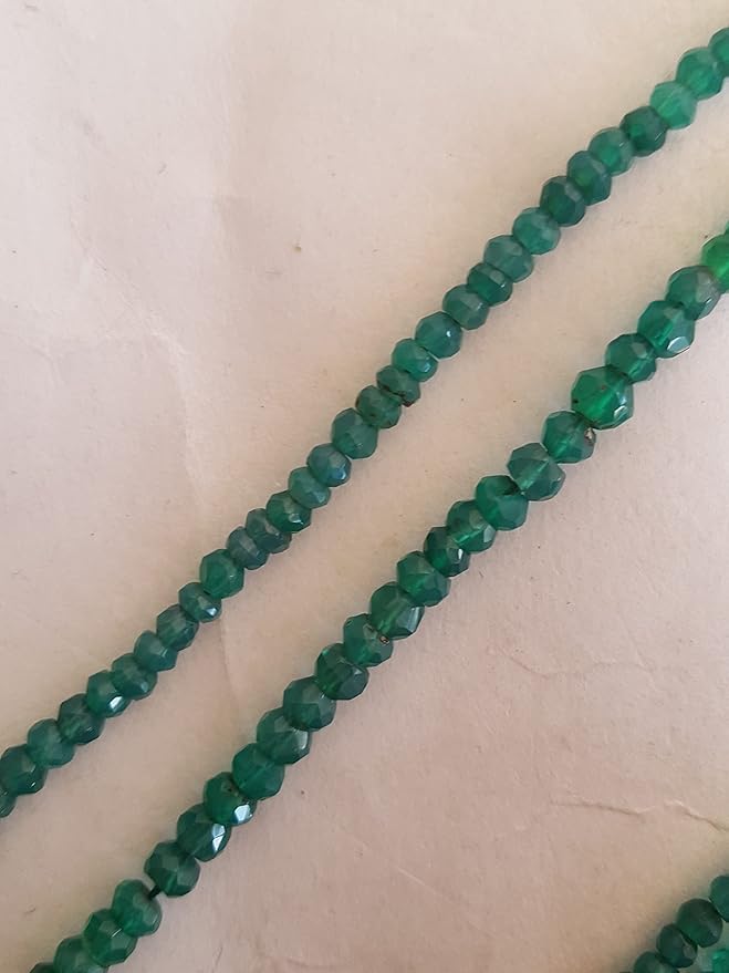 Strands of green onyx beads are displayed closely, highlighting the beads' faceted rondelle design.