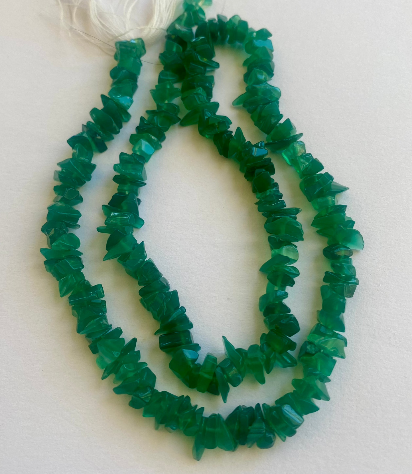 Strands of polished Green Onyx beads, 5-10mm,displaying a bright and eye-catching natural colour.