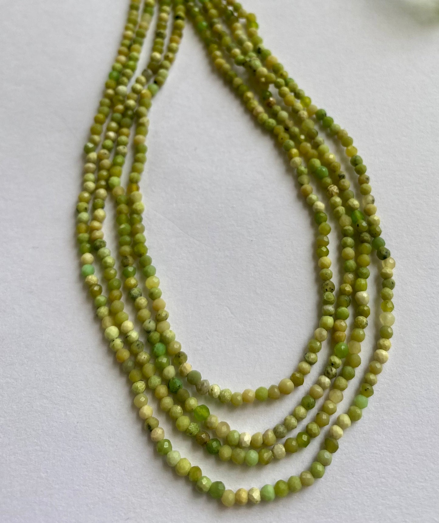 Elegant strands adorned with 2.5mm green faceted rondelle beads, showcasing a sleek design.