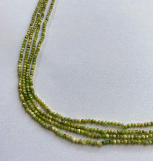 Vibrant strands featuring 2.5mm opal beads in green colour, highlighting their beauty.
