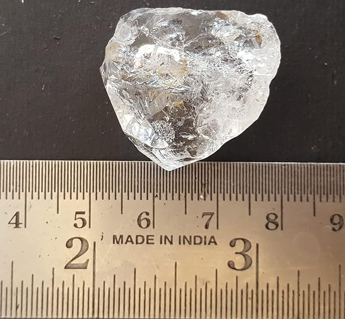 A ruler beside a herkimer diamond rough natural gemstone bead.